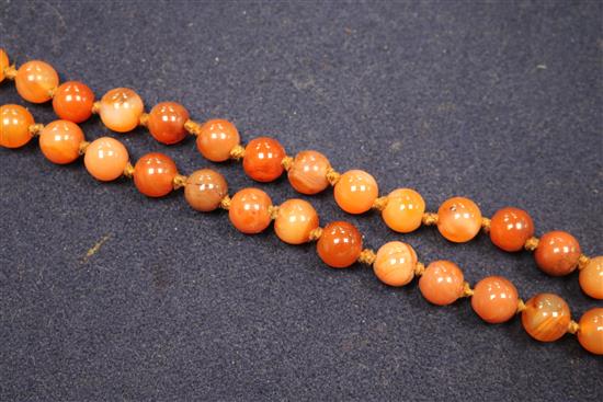 An early 20th century banded agate and other hardstone bead necklace, 80cm.
